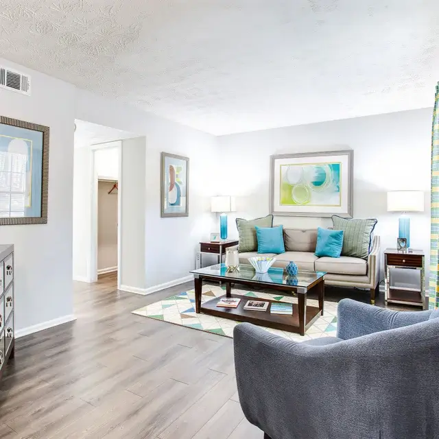 Bright apartment living room with modern flooring and colourful accents at Elea Apartments in Marietta, GA
